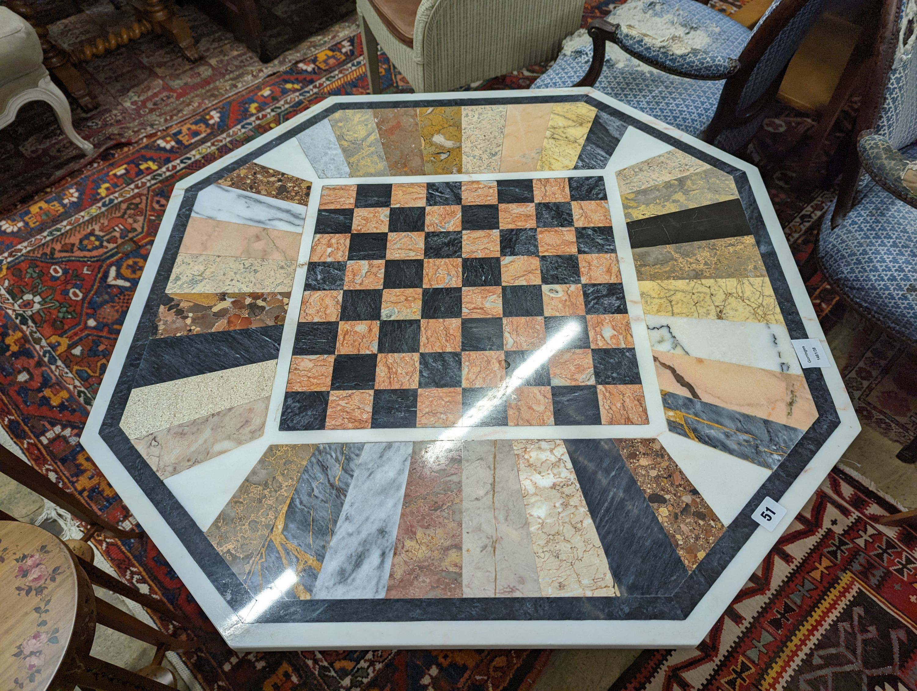 A modern octagonal specimen marble games table, width 91cm, depth 78cm